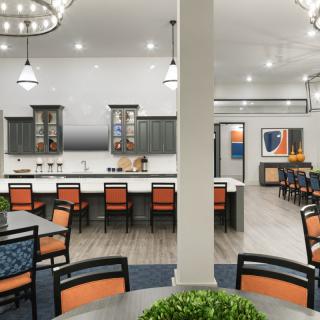 A modern kitchen and dining area with stylish lighting and furniture.