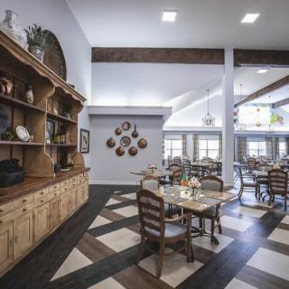 A cozy dining area with wooden furniture and decorative shelves.