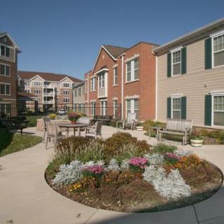 A landscaped garden area with pathways surrounded by residential buildings.