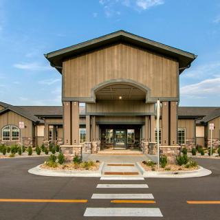 A modern building with a grand entrance and well-maintained landscaping.