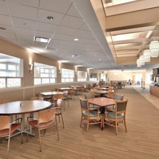 A spacious dining area featuring modern furniture and ample natural light.
