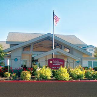 A welcoming front view of a commercial building with an American flag.