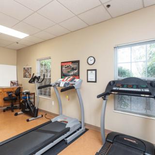 An indoor fitness center with treadmills and a stationary bike.