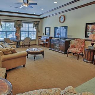 A cozy living room with a comfortable seating area and a large television.