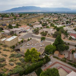 Aerial view of a suburban neighborhood with mountains in the background.