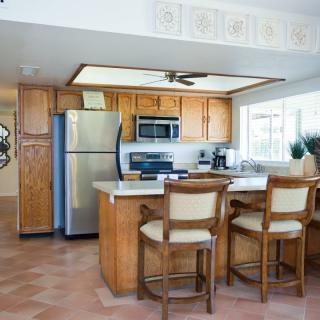 A modern kitchen with wooden cabinets and stainless steel appliances.