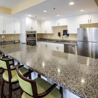 Modern kitchen with granite countertops and stainless steel appliances.