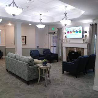 A cozy and well-lit living room with comfortable seating and a fireplace.
