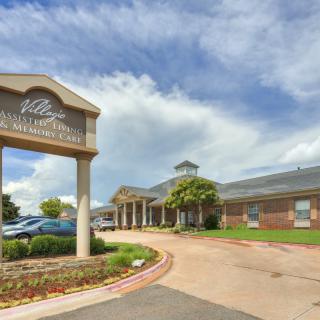 A building with a welcoming driveway and clear blue skies.