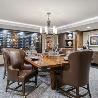 A stylish dining room with a wine cellar and elegant furnishings.