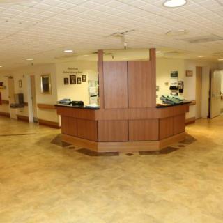A spacious hospital lobby featuring a central reception desk.