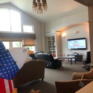 A spacious living room with a television and comfortable seating arrangement.