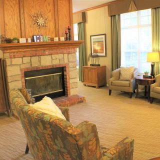 A cozy living room with a fireplace and comfortable seating area.