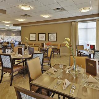 An elegant dining area featuring set tables and comfortable seating.