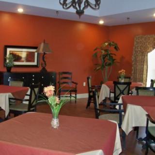 A cozy restaurant dining room with tables and elegant decor.