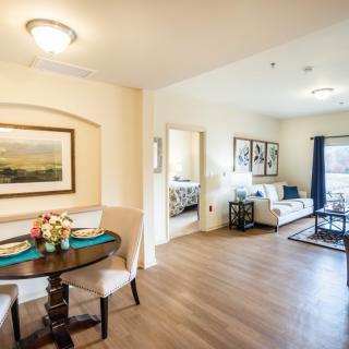 A cozy apartment interior featuring a living room and dining area with elegant decor.