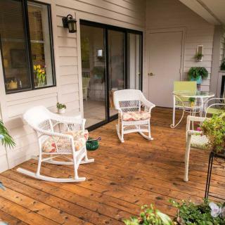 A cozy porch with wooden decking and comfortable outdoor seating.