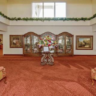 Elegant lobby interior with decorative art and floral arrangement.