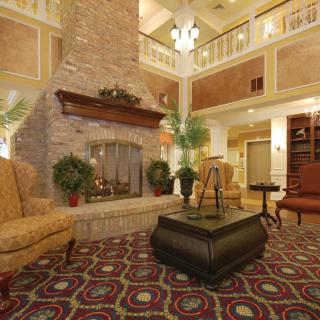 A cozy hotel lobby with a fireplace and comfortable seating.