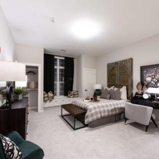 A modern and cozy bedroom with stylish decor and furniture.