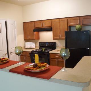A modern kitchen with a dining countertop in an apartment setting.