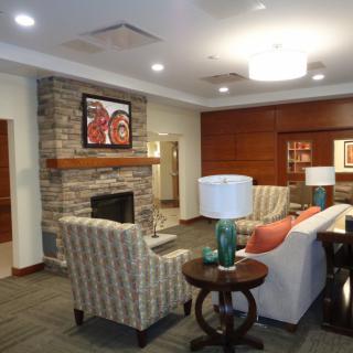 A cozy living room with modern decor, featuring a fireplace and comfortable seating.