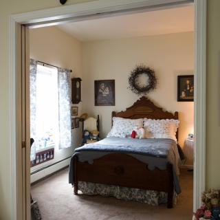 A cozy bedroom with classic wooden furniture and decorative accents.