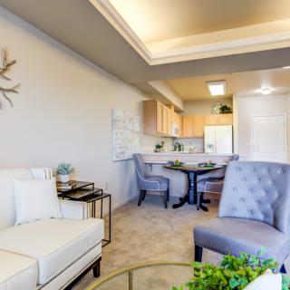 Modern living room with comfortable seating and an open kitchen area.
