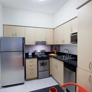 A modern kitchen with stainless steel appliances and ample cabinet space.