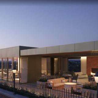 Modern rooftop seating area illuminated in the evening.