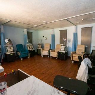 A healthcare facility room equipped with dialysis chairs and medical equipment.