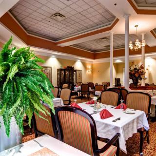 A beautifully decorated restaurant dining area with tables prepared for guests.