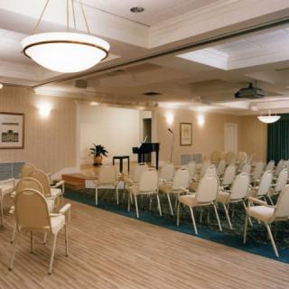 Empty conference room set up with chairs for an event.