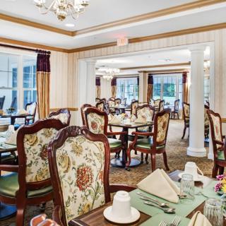 An elegantly decorated dining room with classic furniture and neatly set tables.