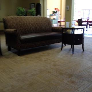 A comfortable waiting area with a sofa and a side table.