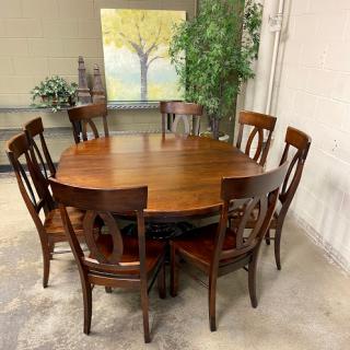 A stylish wooden dining table surrounded by eight chairs, set in a cozy interior.