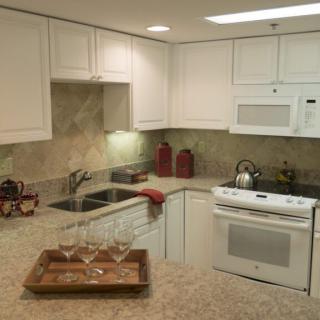 A modern kitchen with white cabinets and stylish decor.