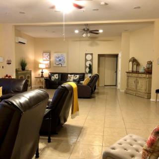 A cozy living room with comfortable seating and ambient lighting.