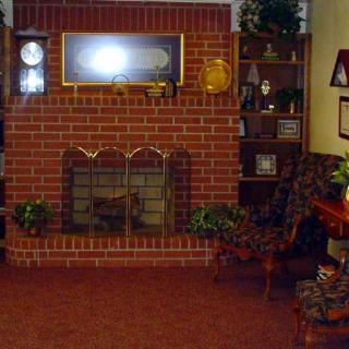 Cozy living room with a brick fireplace and decorative elements.