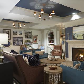 A beautifully designed living room with comfortable seating, a warm fireplace, and elegant decor.