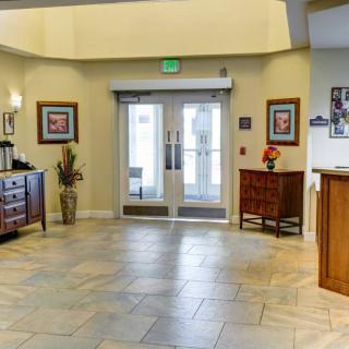 A well-lit lobby area with decorative furniture and tiled flooring.