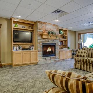 A cozy living room with a fireplace, television, and comfortable seating.