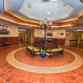 A well-lit lobby area with seating and decorative lighting.
