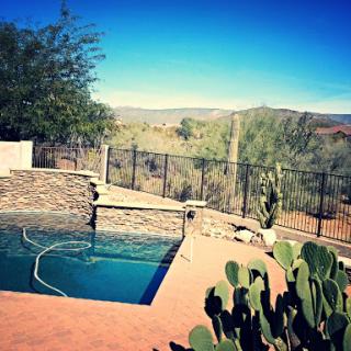 A serene outdoor pool surrounded by a beautiful desert landscape.