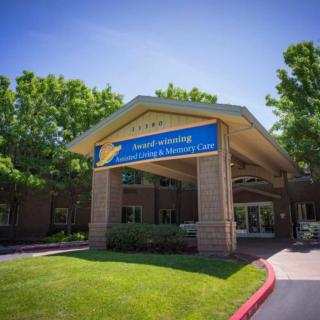 A building entrance with a prominent awning on a sunny day.