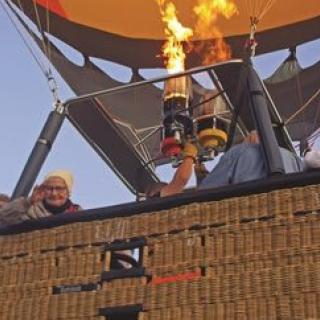 A hot air balloon with passengers preparing for flight.