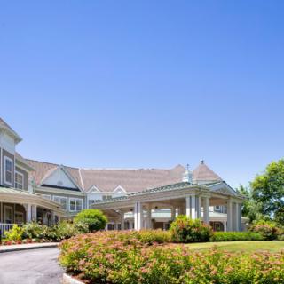 A well-landscaped hotel exterior on a clear day.
