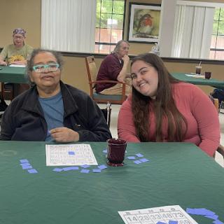 Two friends enjoy a game together at a community center.