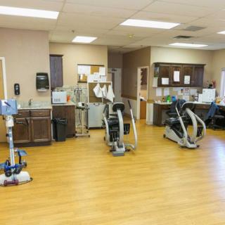 A rehabilitation center featuring various exercise equipment for physical therapy.