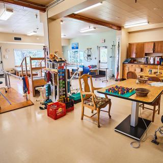 A rehabilitation center featuring various exercise and therapy equipment.